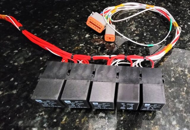 Time to put the tools down for today! New relay panel for a forest rally car. The Deutsch connectors plug into the existing dash panel and new ECU (DTA T12+). 
The relays are:
Fuel pump
Coils and Injectors
Ignition/ECU
Fan
Compressor (air shifter).

And, yes, I know one relay is different :-)